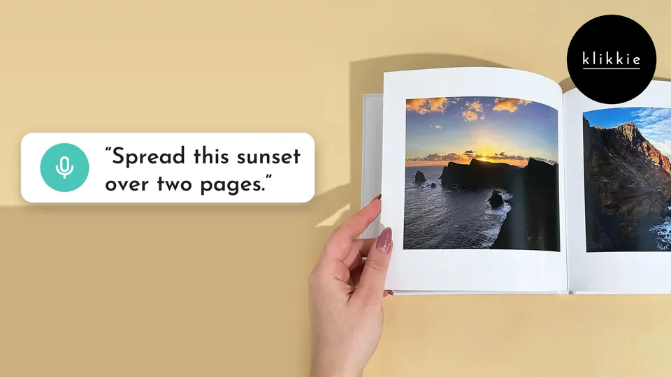 A hand holding an open klikkie photo book with a sunset over the sea, with the words “Spread this sunset over two pages.”