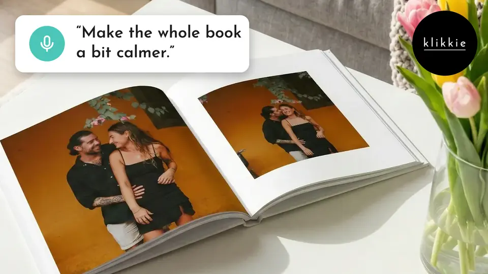 An open klikkie photo book on a coffee table with tulips, with the words “Make the whole book a bit calmer.”